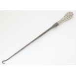 A Victorian button hook with silver handle hallmarked London 1891 maker William Comyns. Approx 16"