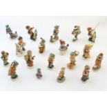 A quantity of Friedel figures to include a boy playing the cello, an artist with easel and