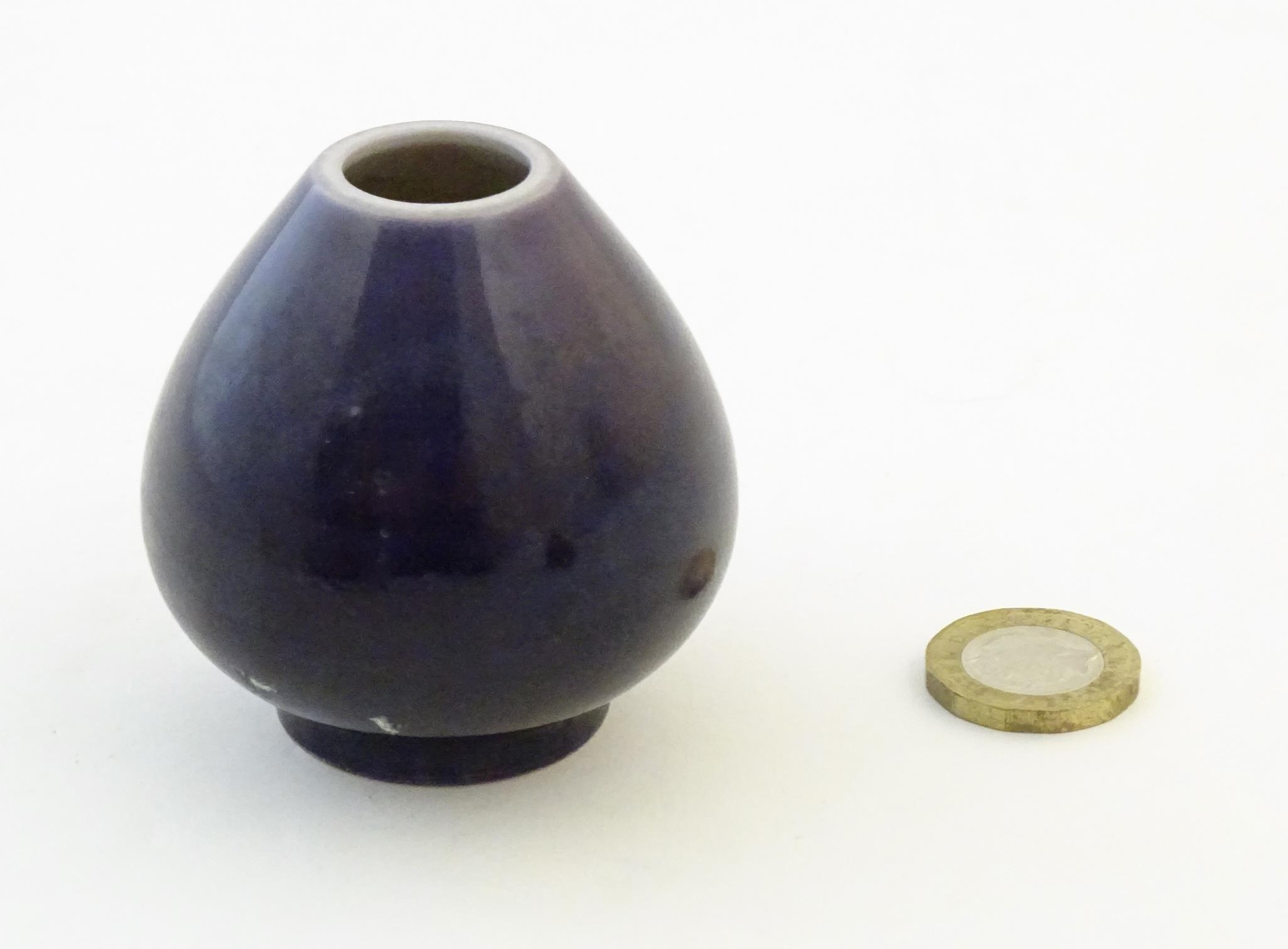 A small Chinese pot of teardrop form with an indigo glaze. Character marks under. Approx. 2" high - Image 2 of 6