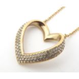 Swarovski : A gilt metal necklace with heart shaped pendant set with Swarovski crystals. The whole