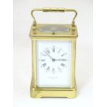 A Victorian brass French repeating carriage clock, the white enamel signed Edward & Sons, Paris, the