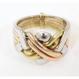 A 14ct gold tricolour puzzle ring. Ring size approx. P 1/2 Please Note - we do not make reference to