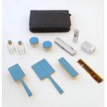 An Art Deco travelling vanity set with blue enamel detail, to include brushes, mirror, scent