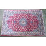 Carpet / Rug : An Isfahan carpet, the red ground with central medallion and floral and foliate