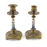 Two late 19th / early 20thC brass candlesticks with blue and white ceramic columns decorated with