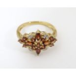 A 9ct gold ring set with garnets and diamonds. Ring size approx. P Please Note - we do not make