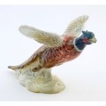 A Beswick model of a pheasant / game bird in flight, model no. 849. Impressed marks under. Approx. 5