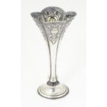 A Victorian silver bud vase with embossed C scroll decoration hallmarked Birmingham 1898, maker