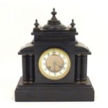 A Victorian slate cased mantle clock, the dial flanked by twin columns and surmounted by a classical