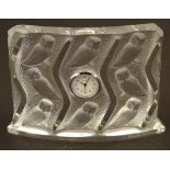 A Lalique mantle clock, the glass surround decorated with owl ( Hulotte ) detail. 5" wide x 3 1/2"