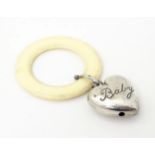 A silver rattle / teether with heart detail, hallmarked Chester 1954, maker WH Collins & Co. Approx.