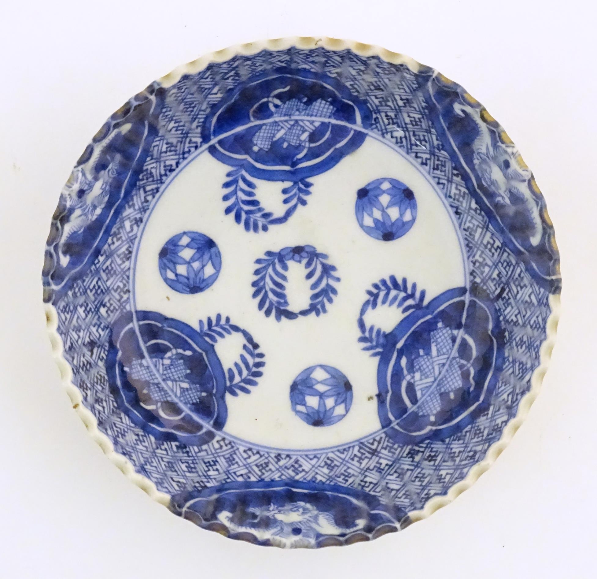 An Oriental blue and white dish with fluted rim, decorated with auspicious scroll symbols, wreaths - Image 4 of 6