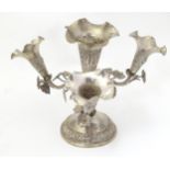 A white metal four flute epergne. Possibly Indian. Approx 6 3/4" high Please Note - we do not make