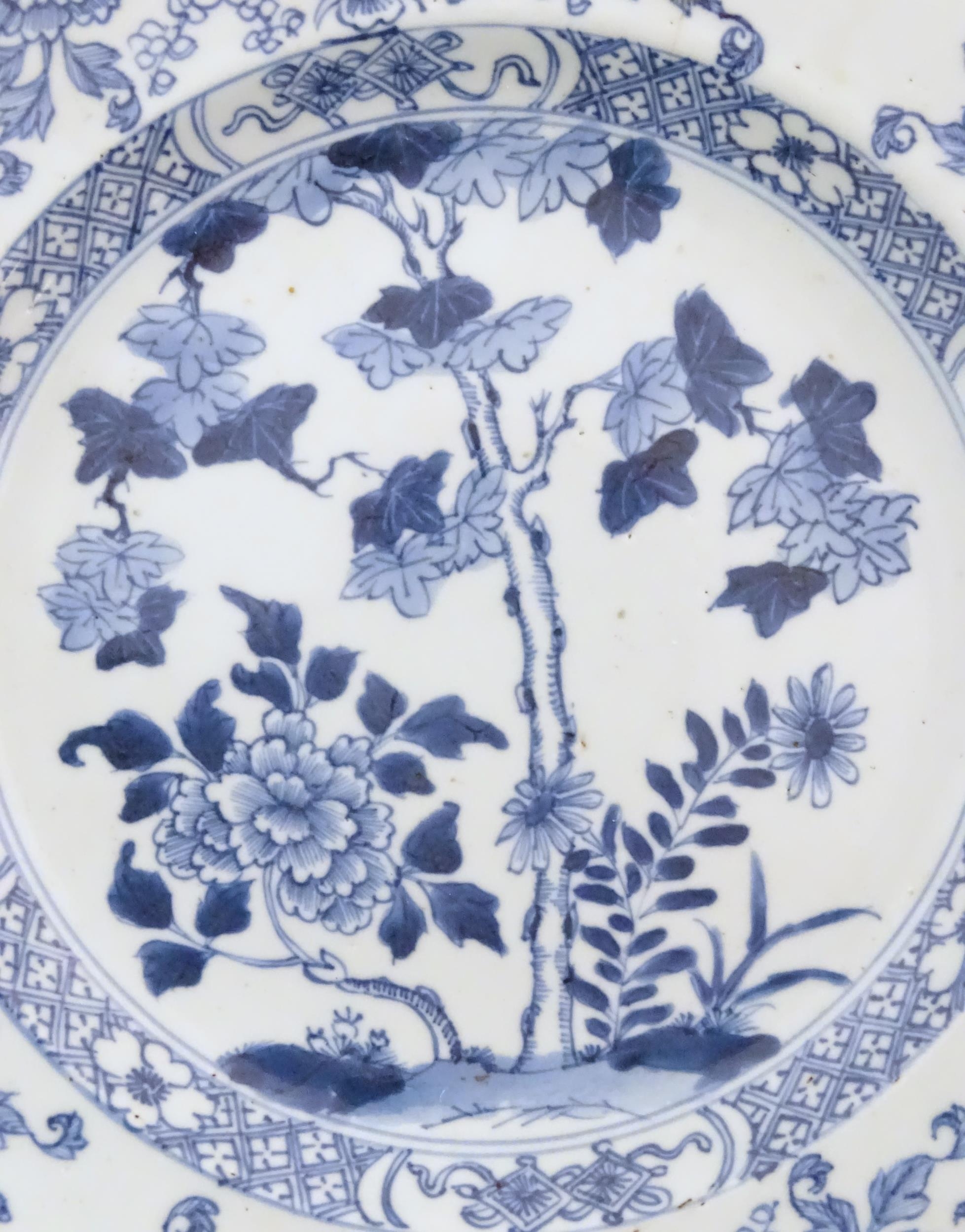 A Chinese blue and white plate decorated with flowers and foliage. With stylised motifs to - Image 2 of 5