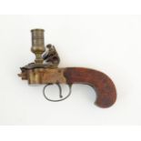 A mid 20thC novelty chamber stick formed as a flintlock pocket pistol, the mechanism with tinder box
