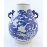 A large Chinese Hu vase with scrolled twin handles, the body decorated in blue and white with the