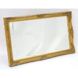 A late 20thC gilt mirror with a moulded frame. 54" wide x 30" high. Please Note - we do not make
