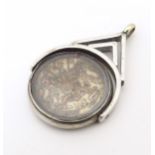 A white metal pendant fob set with East India Company 1 / 12 Anna coin. The whole approx. 1 1/4"