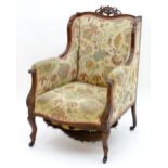 An early 20thC walnut armchair with a pierced cresting rail and moulded frame above cabriole legs.