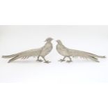 A pair of cast metal table menu holders formed as pheasants. Approx 12" long Please Note - we do not