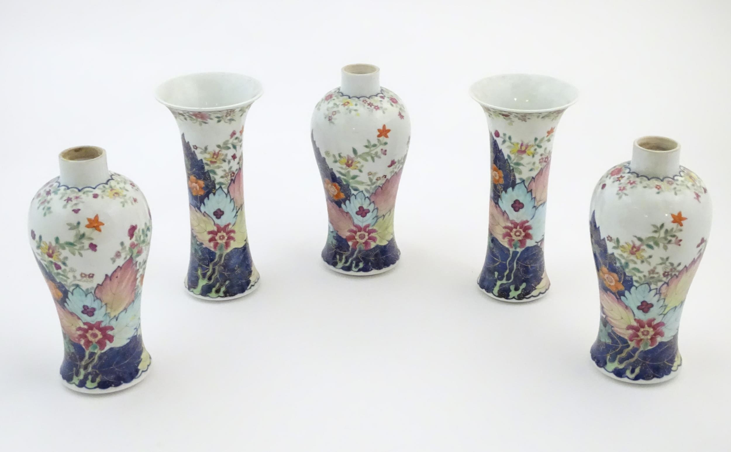 Five Chinese famille rose vases comprising two trumpet vases with floral and foliate detail, and