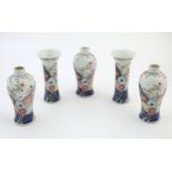 Five Chinese famille rose vases comprising two trumpet vases with floral and foliate detail, and