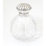 A glass scent / perfume bottle with silver mount and hinged lid hallmarked Sheffield 2001, maker
