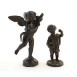 A 20thC cast model of a putto / angel holding a dolphin after Andrea del Verrocchio. Together with a