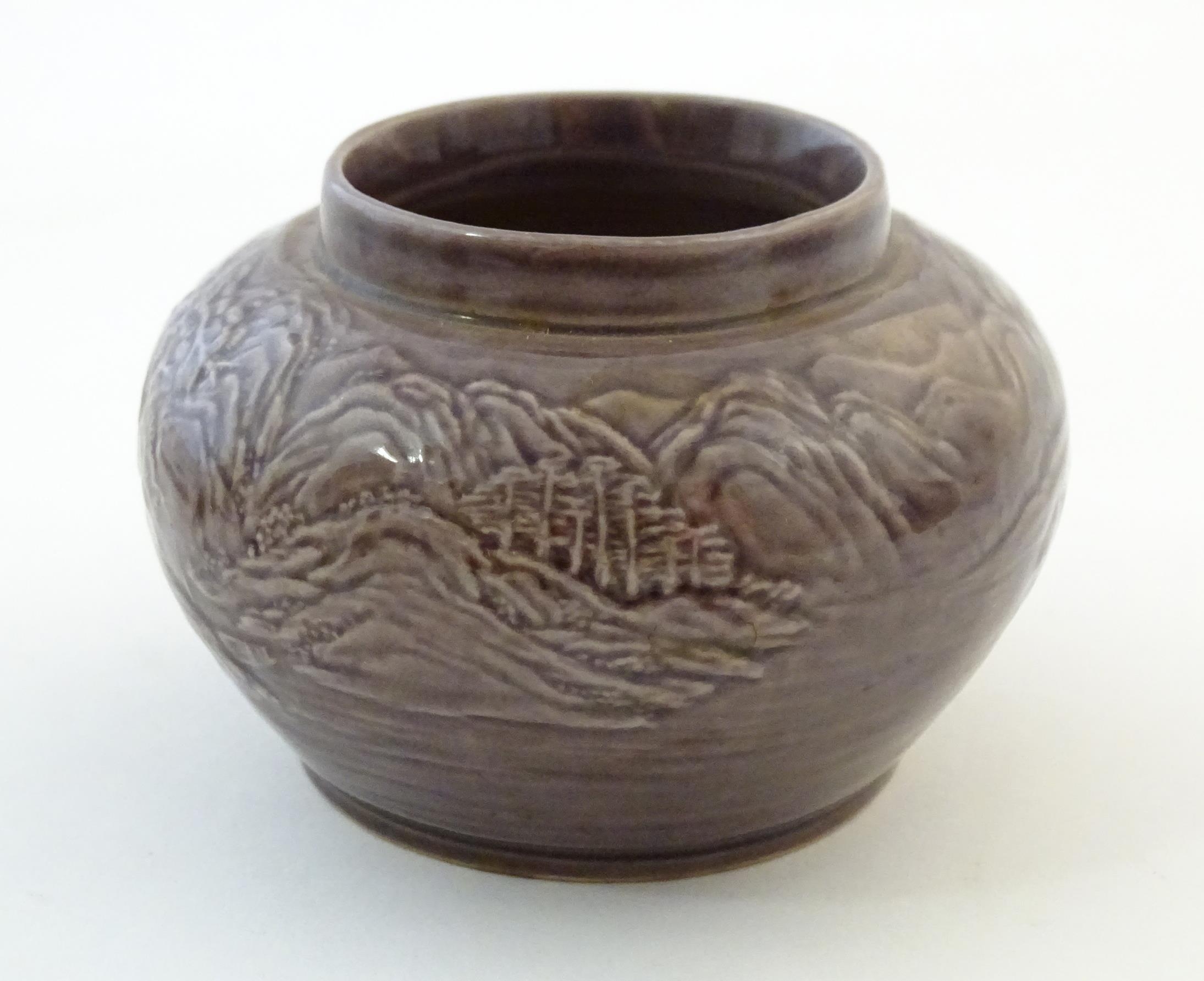 A small Chinese pot of squat form with cast landscape detail. Character marks under. Approx. 2 1/ - Image 5 of 6