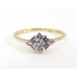 A 9ct gold ring set with tanzanite coloured stones to top. Ring size approx. O 1/2 Please Note -