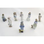 Eight Nao figures comprising Travelling Girl with Dog, model no. 1038; Puppy's Birthday, no. 1045;