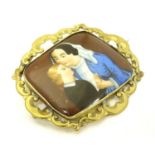 A 19thC Continental brooch set with central ceramic plaque hand painted with mother and child detail