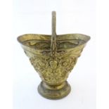 A Victorian brass coal basket by Benham & Froud, of urn form with fixed handle, decorated with masks