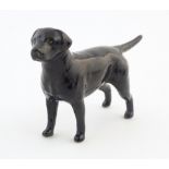 A Beswick model of a black labrador dog, model no. 1956. Marked under. Approx. 3 1/4" high Please