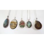 Five silver / white metal necklaces set with various pendants including one with ammonite detail,