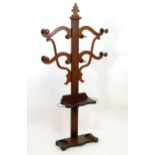 A late 19thC mahogany tree hall stand with shaped branches and turned pegs above a raised platform