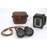 An early 20thC pair of field binoculars with sun shades, the barrels stamped Iris - Paris , Bull