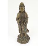 An early 20thC cast model of Guanyin standing on a lotus base. Character marks verso. Approx. 19"