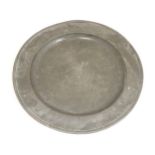 A large 18thC pewter charger plate of circular form, inscribed with initials ' C W M ' and stamped