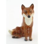 A Beswick model of a seated fox, model no. 1748. Marked under. Approx. 2 3/4" high Please Note -