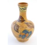 An Art Deco Clews & Co. Chameleon Ware bottle vase with foliate detail. Marked under. Approx. 8 1/4"
