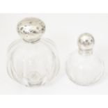 Two glass scent / perfume bottles with silver tops. Largest approx. 4 1/2" high (2) Please Note - we