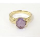 A 9ct gold ring set with oval facet cut amethyst. Ring size approx. R 1/2 Please Note - we do not