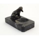 A 20thC marble dish with a cast model of a seated dog. Approx. 2 1/2" high x 4 1/4" wide x 2 1/2"