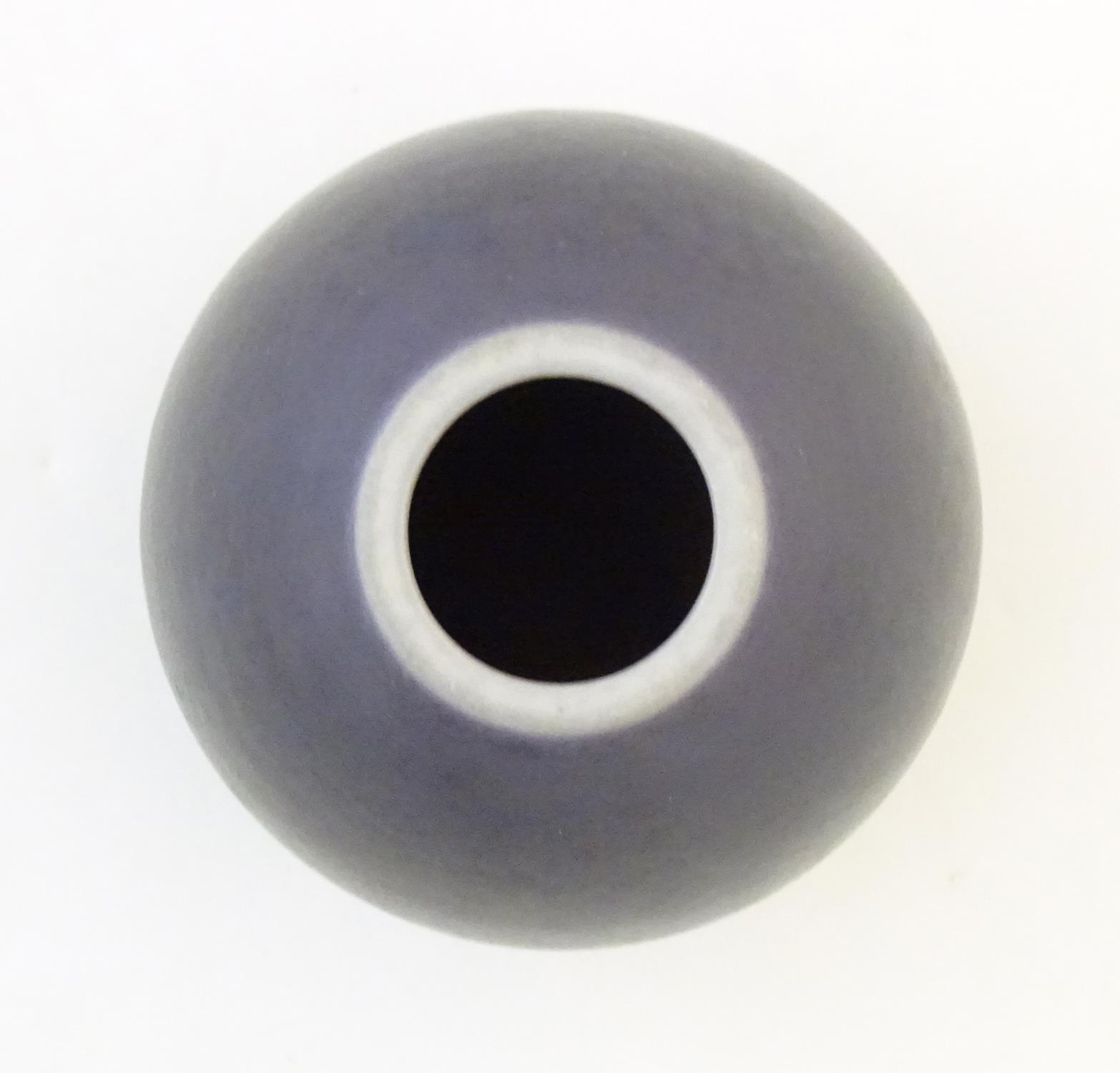 A small Chinese pot of teardrop form with an indigo glaze. Character marks under. Approx. 2" high - Image 5 of 6