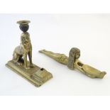 A 20thC brass candlestick formed as an Egyptian seated sphinx with applied detail, the base with