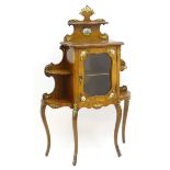 A late 19thC French walnut cabinet with ormolu mounts, Serves porcelain plaques and having a