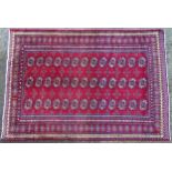 Carpet / Rug : A Turkoman rug, the red ground with bands of medallions and vignettes Approx. 70 1/2"