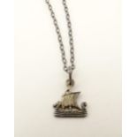 Scottish Jewellery : A white metal pendant and chain, the pendant formed as a Viking long boat. In a