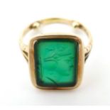 A late 19th / early 20thC 9ct gold ring set with green stone seal to top depicting a Classical